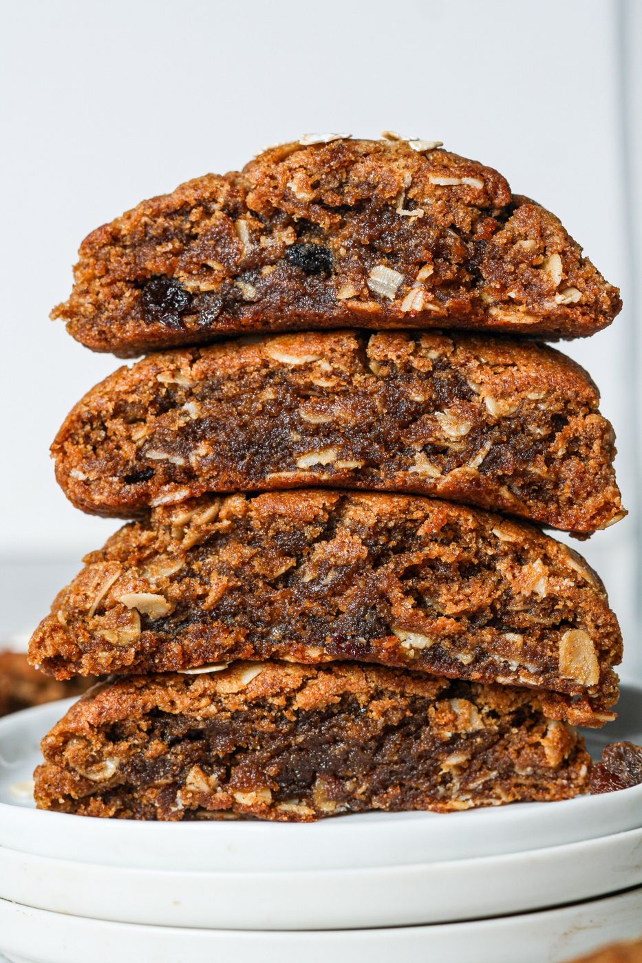 A stack of Sweet Addison's oatmeal raisin cookies split open, gooey crumb visible