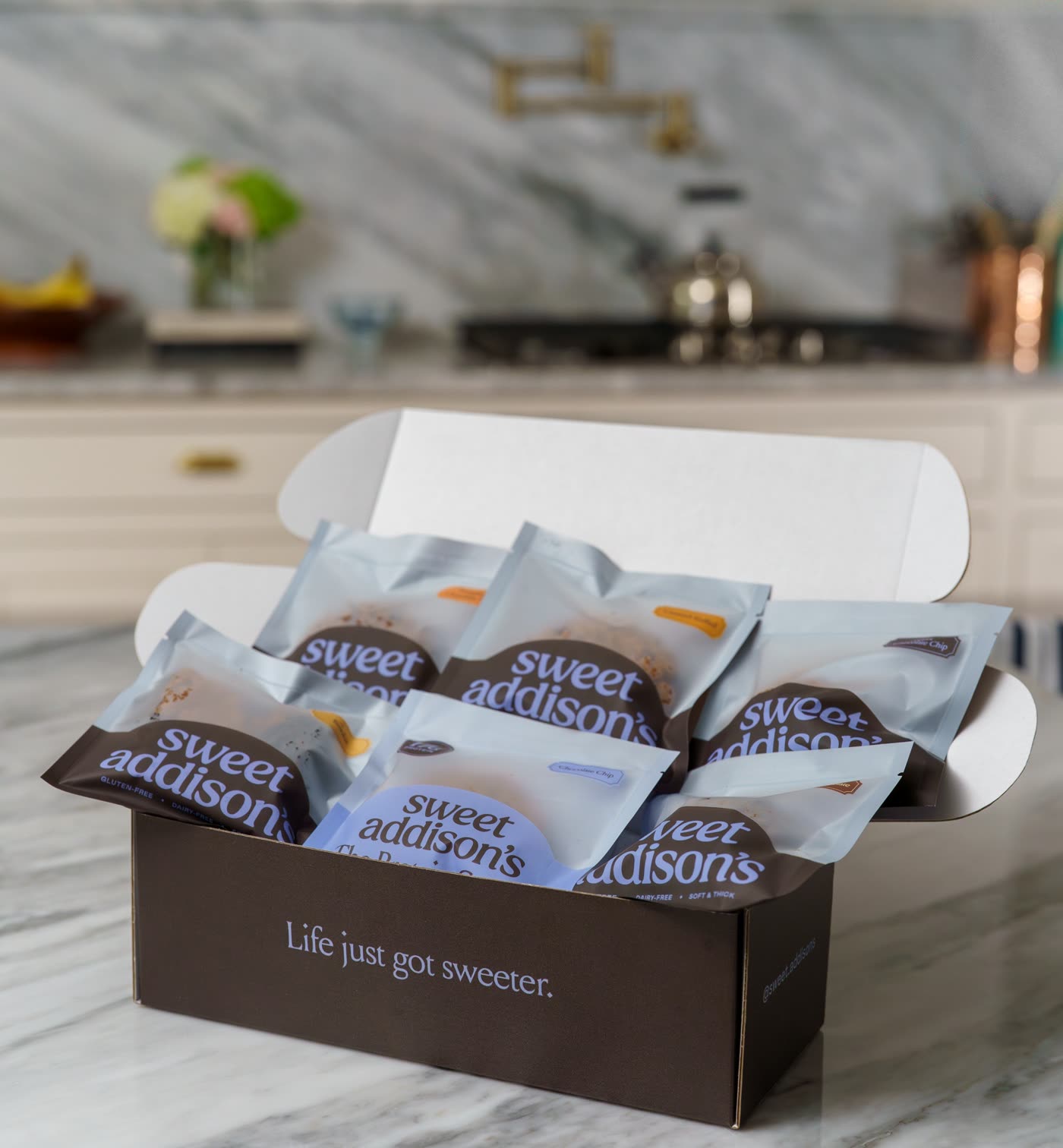 A Sweet Addison's gift box packed with individually wrapped cookies, ready to ship