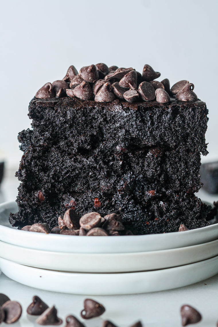 Protein brownie stacked on a plate with chocolate chips
