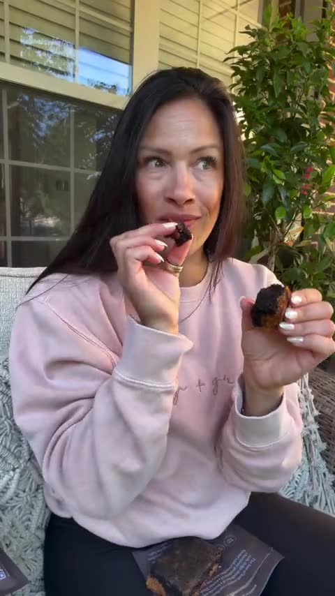 A customer tasting her first Sweet Addison's brownie